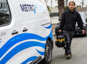 Plumber loading tool kit into van